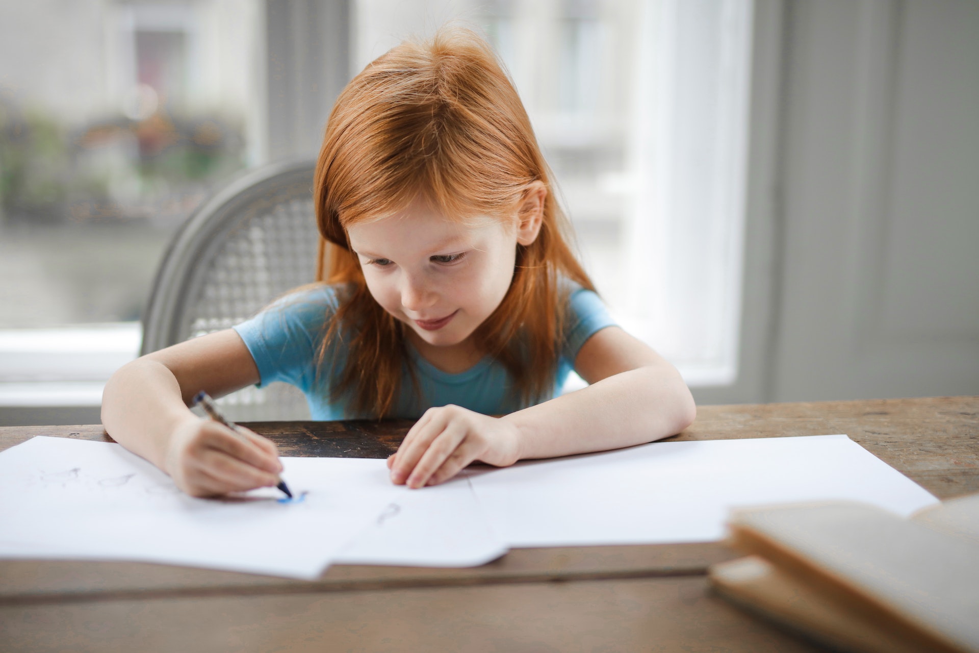 A child drawing in a table